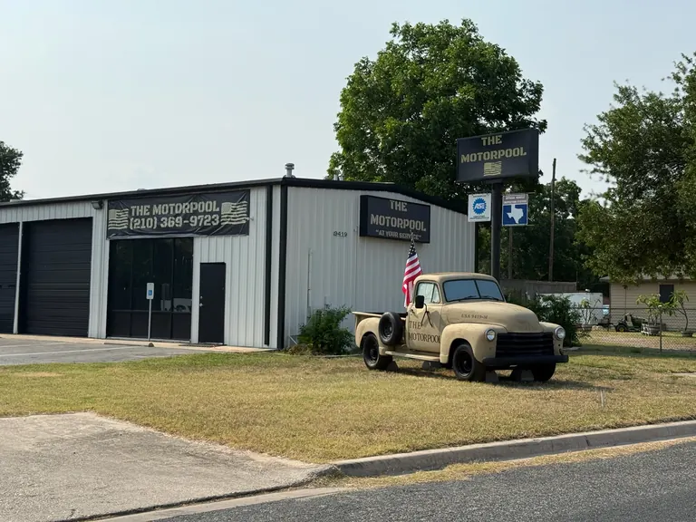 The Motorpool Full Service building at 9419 Poteet Jourdanton Fwy, right down the block from Palo Alto College in South San Antonio, with its signs and the vintage Motorpool truck out front